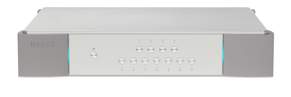 Silver electronic device with multiple buttons and indicator lights on its front panel, designed for audio control.